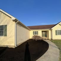 Fresh mulch bed installed along a home